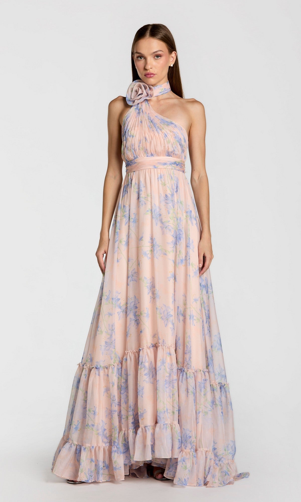 A woman wearing the Mac Duggal 68101 Long Print Halter Formal Dress, a floor-length evening gown, stands against a plain light background.